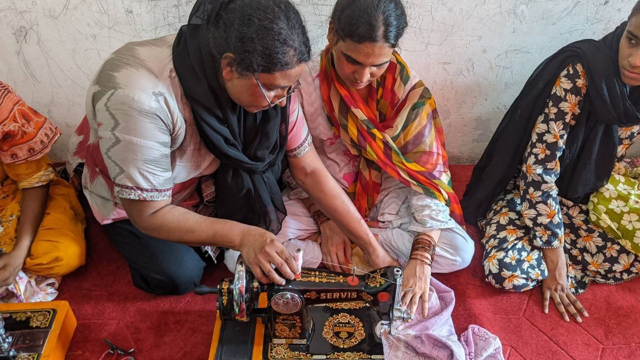 A woman being trained to use a sewing machine as part of a livelihood business